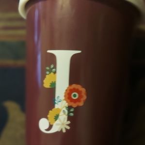 Ceramic travel cup with the letter 'J'